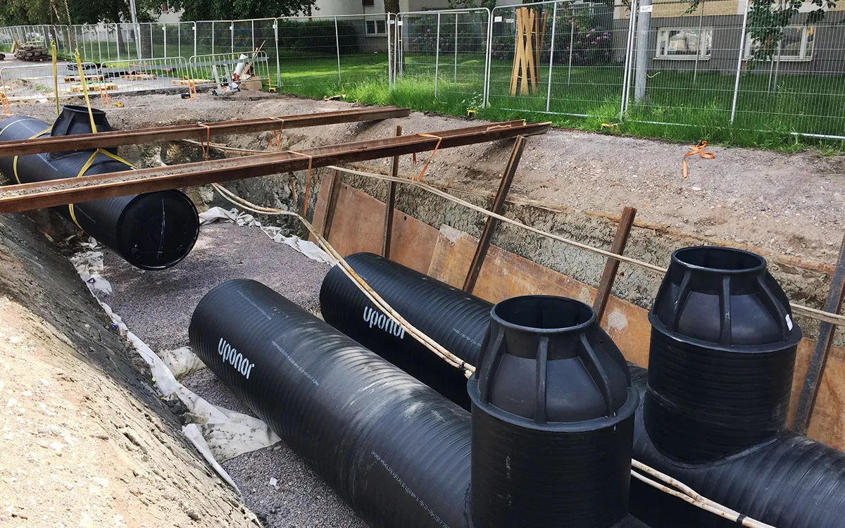 Installation d’un système de traitement souterrain des eaux pluviales avec de grandes cassettes de filtration noires placées dans une tranchée préparée