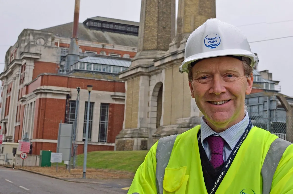 Michael Chipps, Chief Scientist at Thames Water, wearing a safety helmet and high-visibility jacket, standing outside a Thames Water treatment facility in London