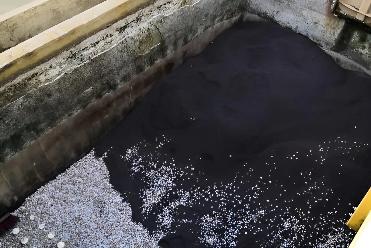 Partially filled filtration basin showing layers of black Filtralite filter media