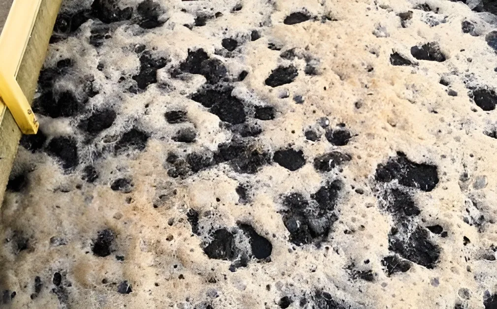 Close-up of active Filtralite filter media covered in foam during water treatment process