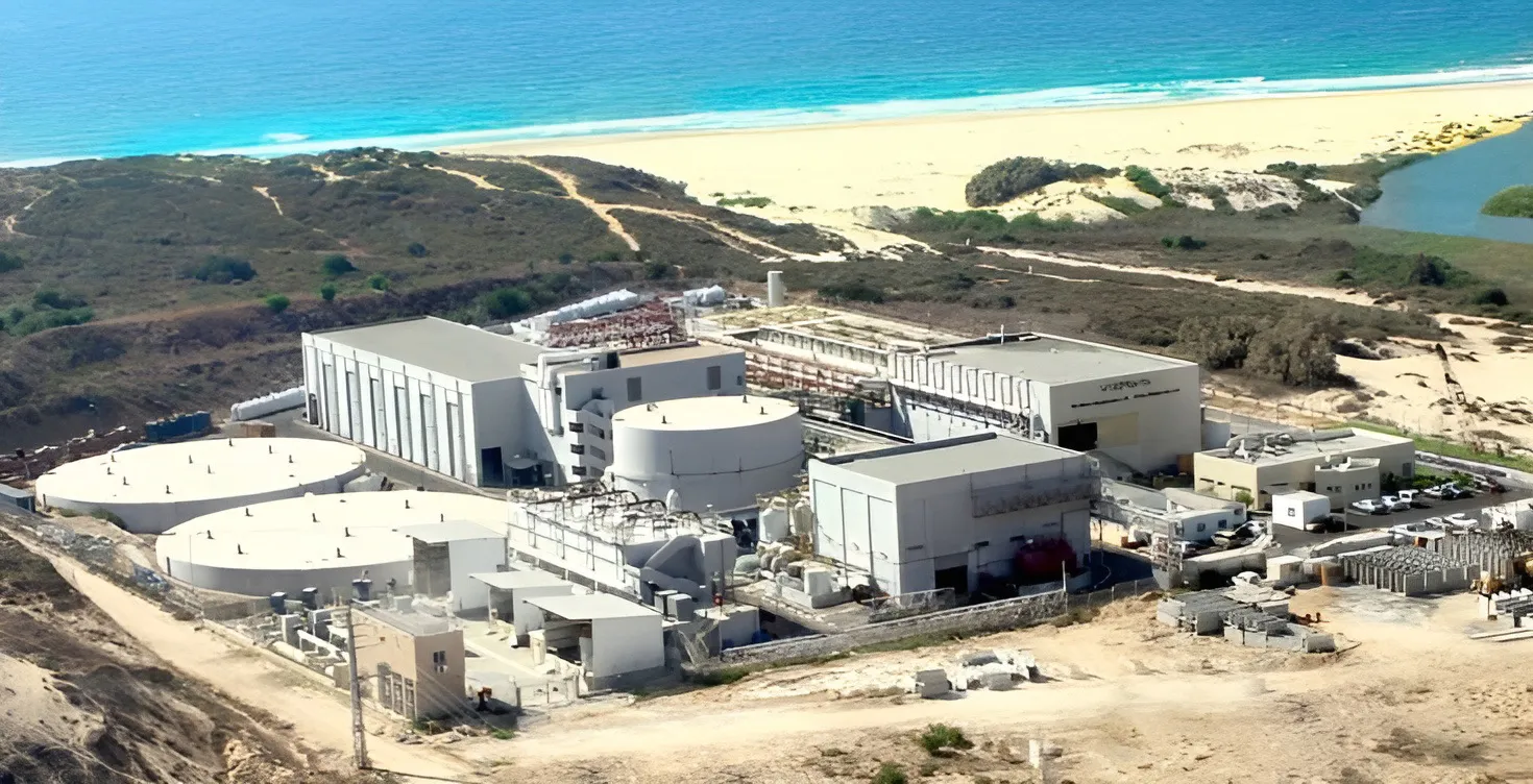 Aerial view of the Palmachim desalination plant near the coastline with sandy beaches and the sea in the background