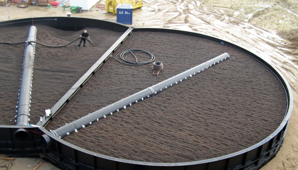 Worker filling the odour treatment filter at the Nature Energy Nordfyn biogas plant